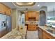 Spacious kitchen featuring granite countertops, stainless steel appliances, and custom wood cabinetry at 607 Vintage Way, Brandon, FL 33511