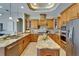 Well-lit kitchen with granite countertops, stainless steel appliances, and custom wood cabinetry at 607 Vintage Way, Brandon, FL 33511