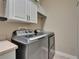 Laundry room with cabinets and stainless steel washer and dryer at 607 Vintage Way, Brandon, FL 33511