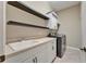 Functional laundry room with sink, storage cabinets, and modern washer and dryer at 607 Vintage Way, Brandon, FL 33511