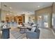 Open-concept living room with modern decor, including a plush sofa, area rug, and bar seating to the kitchen at 607 Vintage Way, Brandon, FL 33511