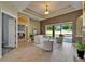 Bright living room with modern furniture, tile flooring, and sliding glass doors at 607 Vintage Way, Brandon, FL 33511