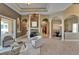 Spacious open floor plan with a stone fireplace, modern tile flooring, and archways to the kitchen and dining room at 607 Vintage Way, Brandon, FL 33511
