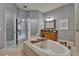 Bright bathroom showcasing soaking tub, vanity, and entry to shower area at 607 Vintage Way, Brandon, FL 33511