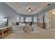 Spacious bedroom features tray ceiling, plantation shutters, and neutral decor at 607 Vintage Way, Brandon, FL 33511