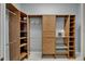 Custom walk-in closet features wood organizers and shelving for optimal storage at 607 Vintage Way, Brandon, FL 33511