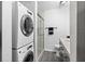 Bathroom with stacked washer and dryer and a glass enclosed shower at 716 Lyndhurst St # 702, Dunedin, FL 34698