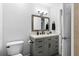 Well-lit bathroom offers a gray vanity, modern fixtures, and updated lighting at 716 Lyndhurst St # 702, Dunedin, FL 34698