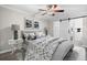 Comfortable bedroom featuring a ceiling fan, neutral walls, and an en suite laundry room at 716 Lyndhurst St # 702, Dunedin, FL 34698