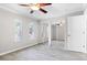 Bright bedroom features wood-look flooring, ceiling fan, and mirrored closet doors at 716 Lyndhurst St # 702, Dunedin, FL 34698