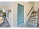 Unit 702 features a quaint entrance with a light blue door and gray stairs leading to upper level at 716 Lyndhurst St # 702, Dunedin, FL 34698