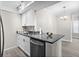 Modern kitchen features white cabinets, stainless steel appliances, and granite countertops at 716 Lyndhurst St # 702, Dunedin, FL 34698