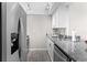 Well-lit kitchen with stainless steel appliances, granite countertops, and modern lighting at 716 Lyndhurst St # 702, Dunedin, FL 34698