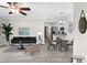 Bright living room featuring modern decor, gray wood floors, and an open floor plan at 716 Lyndhurst St # 702, Dunedin, FL 34698