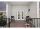 Enclosed brick patio with black metal outdoor furniture in front of french doors at 716 Lyndhurst St # 702, Dunedin, FL 34698