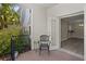 Cozy patio with an outdoor chair and potted plants overlooking the interior of the home at 716 Lyndhurst St # 702, Dunedin, FL 34698