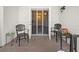 Enclosed brick patio with black metal outdoor furniture in front of french doors at 716 Lyndhurst St # 702, Dunedin, FL 34698