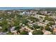 The aerial view shows a community with tree-lined streets, houses, and municipal buildings, plus a distant bay at 809 Scotland St, Dunedin, FL 34698