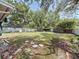 A view of the large backyard featuring a white fence and mature shade trees at 809 Scotland St, Dunedin, FL 34698