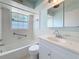 Bright bathroom featuring white tile, a shower-tub combo and modern fixtures at 809 Scotland St, Dunedin, FL 34698