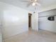 Neutral bedroom featuring a ceiling fan, a closet, and neutral walls and flooring at 809 Scotland St, Dunedin, FL 34698