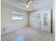 Angle view of a bedroom featuring two windows, ceiling fan and a closet at 809 Scotland St, Dunedin, FL 34698