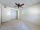 View of a bright bedroom featuring a window, ceiling fan and closet at 809 Scotland St, Dunedin, FL 34698