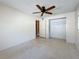 View of bedroom featuring carpeted flooring, ceiling fan and closet space at 809 Scotland St, Dunedin, FL 34698