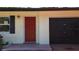 Charming single Gathering home with a red front door and attached one car garage at 809 Scotland St, Dunedin, FL 34698