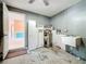 Unfinished garage area with water heater, sink, cabinets and doorway to the main residence at 809 Scotland St, Dunedin, FL 34698