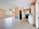 Open concept kitchen view from the hall, showing refrigerator and kitchen sink at 809 Scotland St, Dunedin, FL 34698