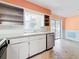 Angle view of kitchen featuring appliances, cabinets, backsplash and a window at 809 Scotland St, Dunedin, FL 34698