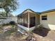 Exterior view of the sunroom with screen walls and a sliding door to the backyard at 809 Scotland St, Dunedin, FL 34698