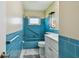 Vintage blue bathroom with tile, bath, vanity and marble floors at 10036 40Th N St # 3, Pinellas Park, FL 33782