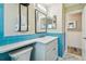 Remodeled bathroom with blue tile, modern vanity, and marble-look flooring at 10036 40Th N St # 3, Pinellas Park, FL 33782