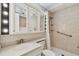 Bright bathroom featuring a walk-in shower, grab bars, built-in shelving, and a white vanity at 10036 40Th N St # 3, Pinellas Park, FL 33782