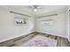 Well-lit bedroom showcasing wood-look floors, a ceiling fan, and neutral walls at 10036 40Th N St # 3, Pinellas Park, FL 33782
