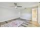 Bright bedroom with en-suite bathroom featuring wood-look floors and a ceiling fan at 10036 40Th N St # 3, Pinellas Park, FL 33782