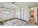 Bright bedroom features two closets, wood-look floors, ceiling fan, and neutral walls at 10036 40Th N St # 3, Pinellas Park, FL 33782