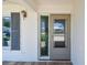 Inviting entryway featuring a decorative glass side panel, neutral door paint, and brick porch at 10036 40Th N St # 3, Pinellas Park, FL 33782