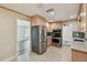 Well-equipped kitchen with stainless steel appliances, light wood cabinets, and a pass-through window at 10036 40Th N St # 3, Pinellas Park, FL 33782