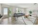 Stylishly furnished living room featuring wood floors, a decorative glass door, and plenty of natural light at 10036 40Th N St # 3, Pinellas Park, FL 33782
