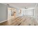 Spacious living room featuring wood-look flooring and neutral paint, providing an airy atmosphere at 10036 40Th N St # 3, Pinellas Park, FL 33782