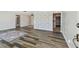 Open-concept living room featuring modern flooring, neutral color scheme, and a pass-through to the kitchen at 10036 40Th N St # 3, Pinellas Park, FL 33782