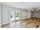 Light-filled living room with sliding glass doors to outside, complemented by wood-look flooring at 10036 40Th N St # 3, Pinellas Park, FL 33782