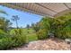 Paver patio overlooking beautiful green landscaping and expansive lawn at 10036 40Th N St # 3, Pinellas Park, FL 33782