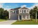 Charming two-story home with a well-manicured lawn and attractive curb appeal at 10573 Farm Hill Ave, Land O Lakes, FL 34638