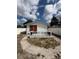 Cozy backyard retreat with a small patio, orange French doors, and a well-maintained white fence at 1318 W Broad St, Tampa, FL 33604