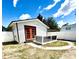 Cozy home exterior with orange French doors and small patio area within a well-maintained yard at 1318 W Broad St, Tampa, FL 33604