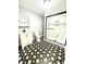 Updated bathroom featuring modern vanity, toilet, and shower with black and white marble style tile at 1318 W Broad St, Tampa, FL 33604